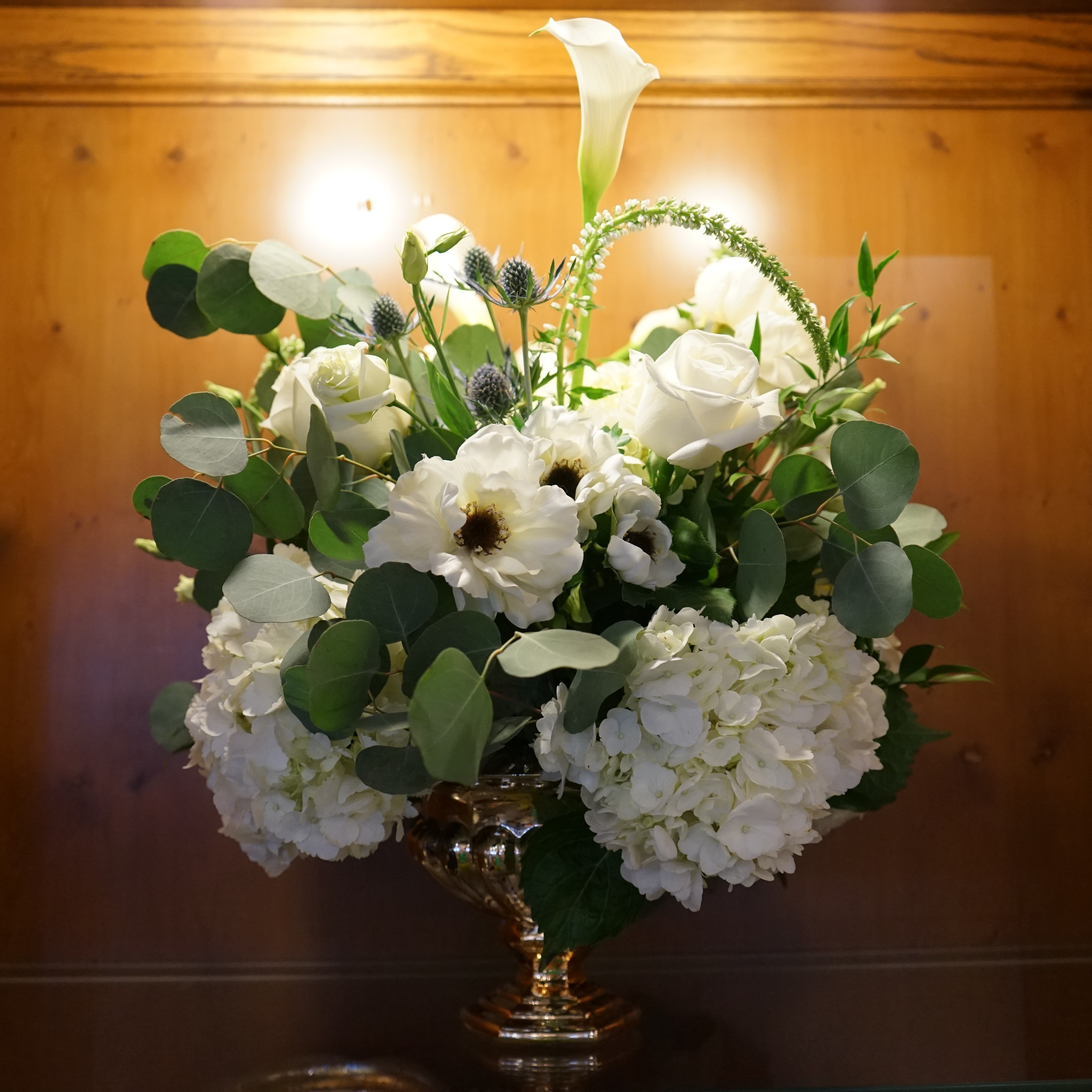 White roses mixed with other white flowers and greenery arranged by flower delivery service The Plant Gallery in New Orleans, LA