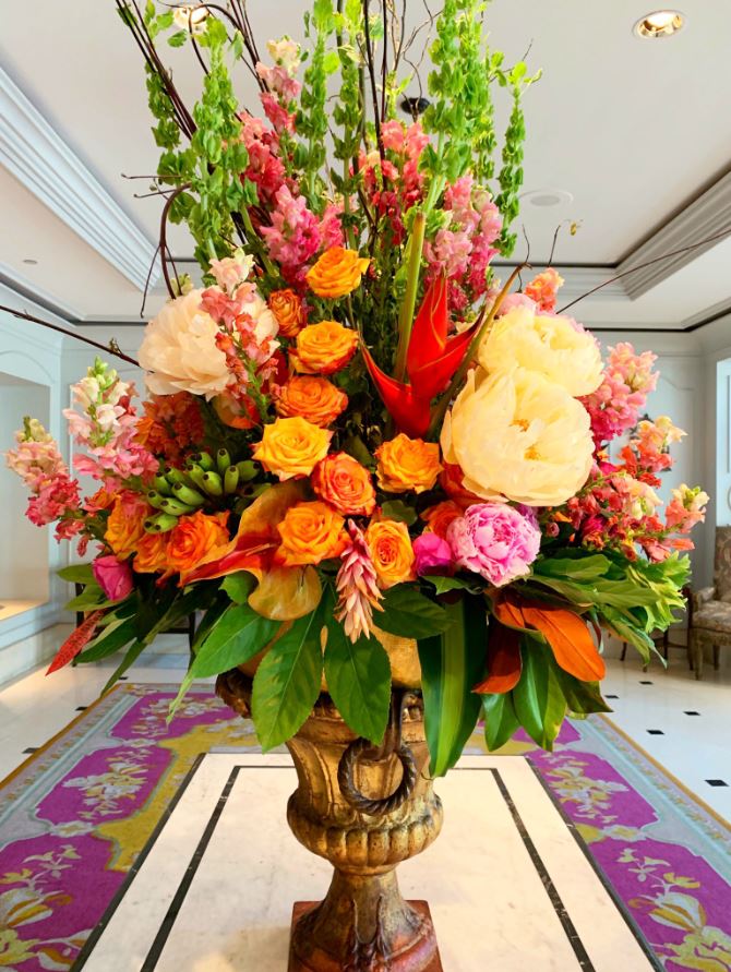 Orange, yellow, and pink funeral flowers arranged by The Plant Gallery in New Orleans, LA
